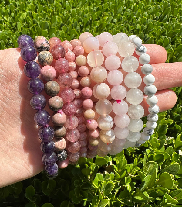 howlite, amethyst, rhodonite, flower agate, clear quartz and strawberry quartz crystal bracelets at the serenity space